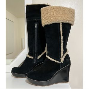 Tall UGG suede shearling wedge boots in black.